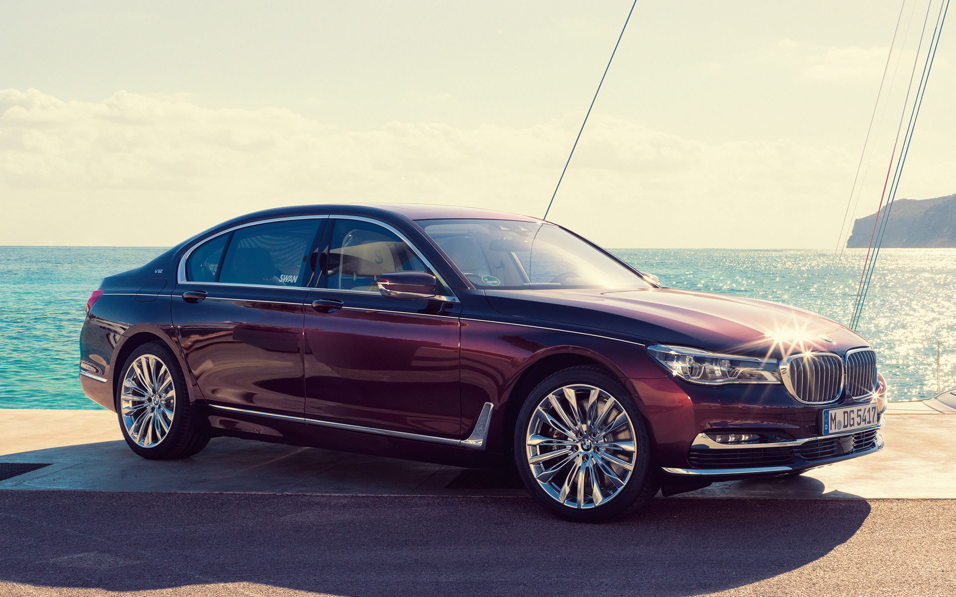 BMW Individual M760Li inspired by Nautor’s Swan G12 2017 three-quarter side view standing at pier in front of sailing yacht in bay